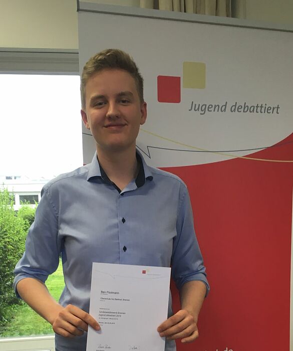 Junge hält Siegerurkunde in den Händen.