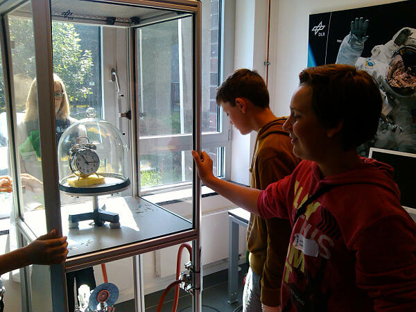 Schüler vor einer Vakuumglocke